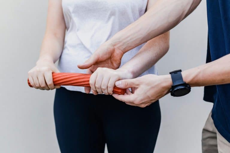 Physioübung mit Therapeut und Patientin in einer Reha bzw. Kur.